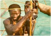 A Sentinelese man goes fishing in a dugout canoe.